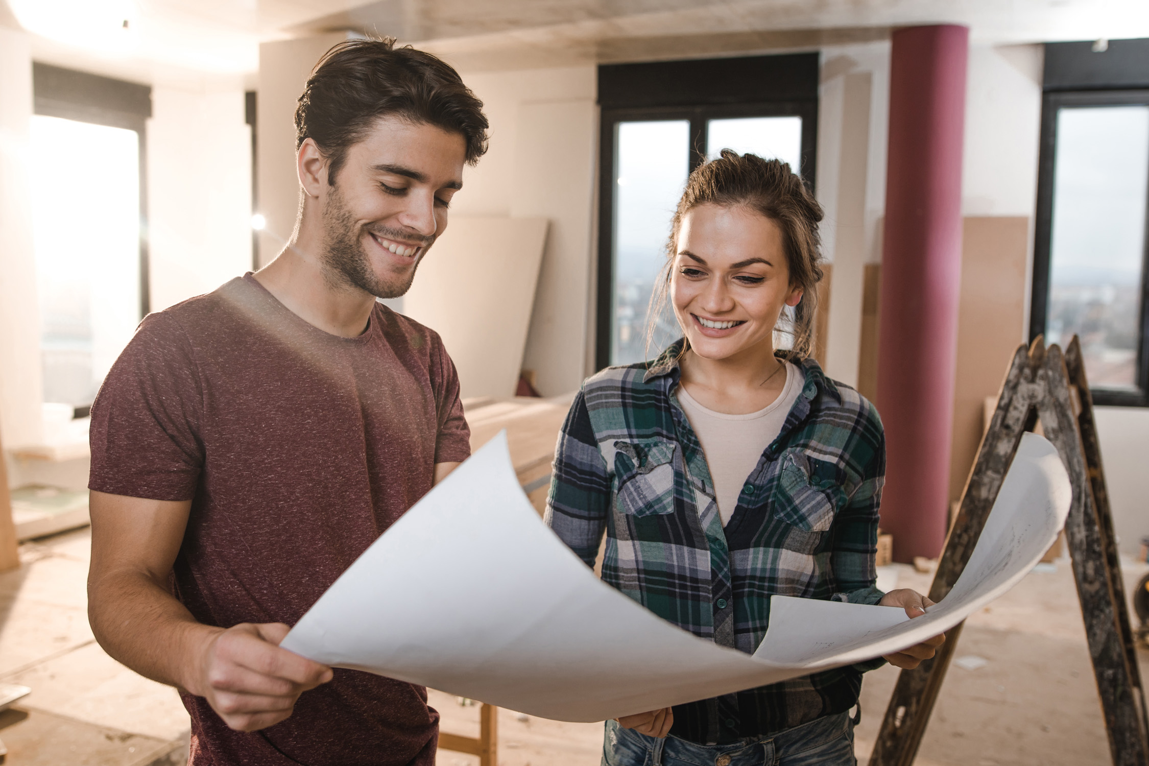 Couple looking at plans for home renovation