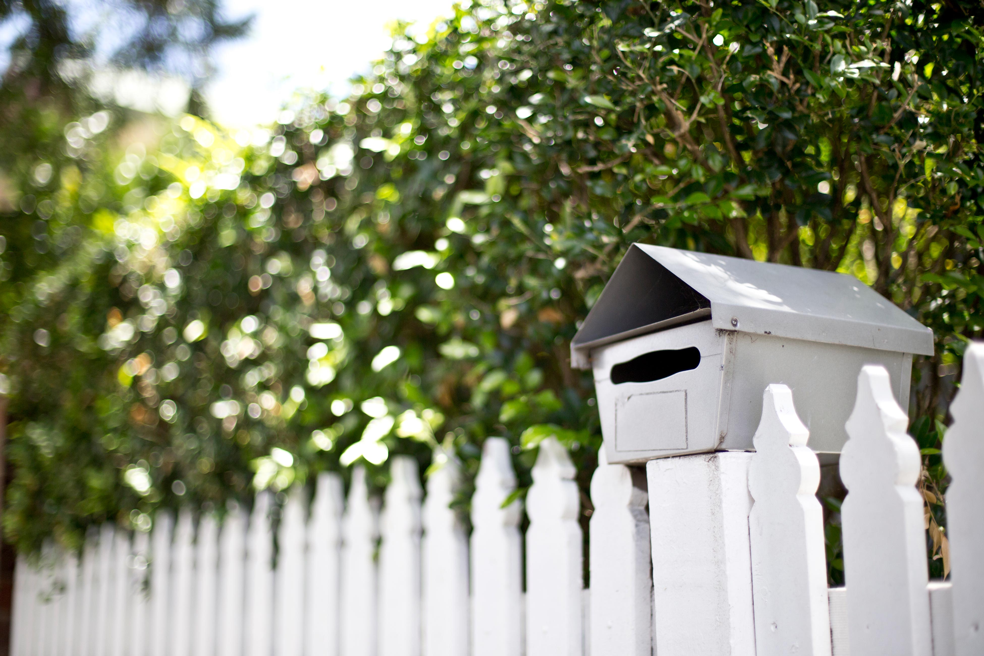 Letterbox and white picket fence