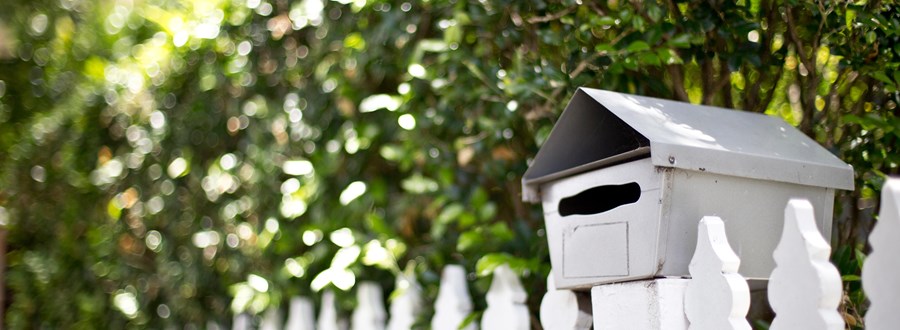 Letterbox and white picket fence