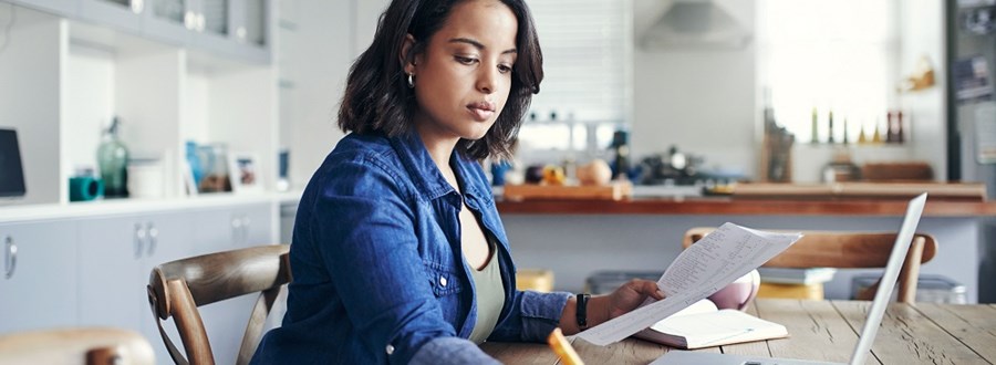 Woman paying bills from bank account online Woman paying bills from bank account online
