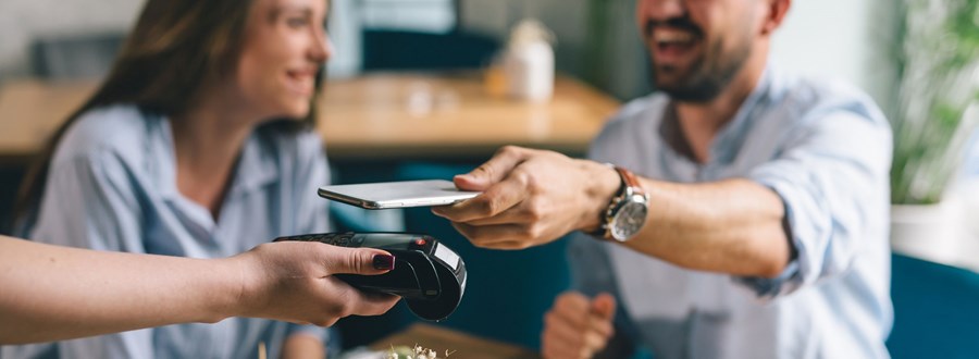 Couple paying with contactless payments in-store