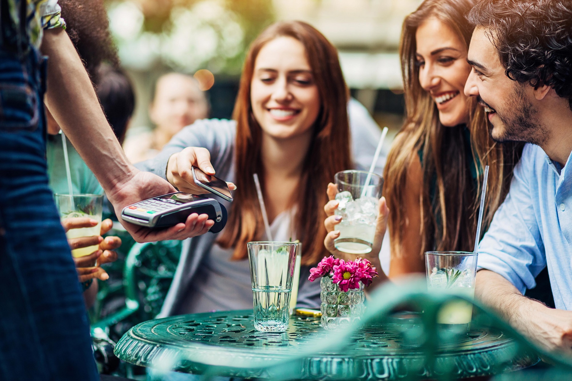 Friends out at lunch paying with their credit card